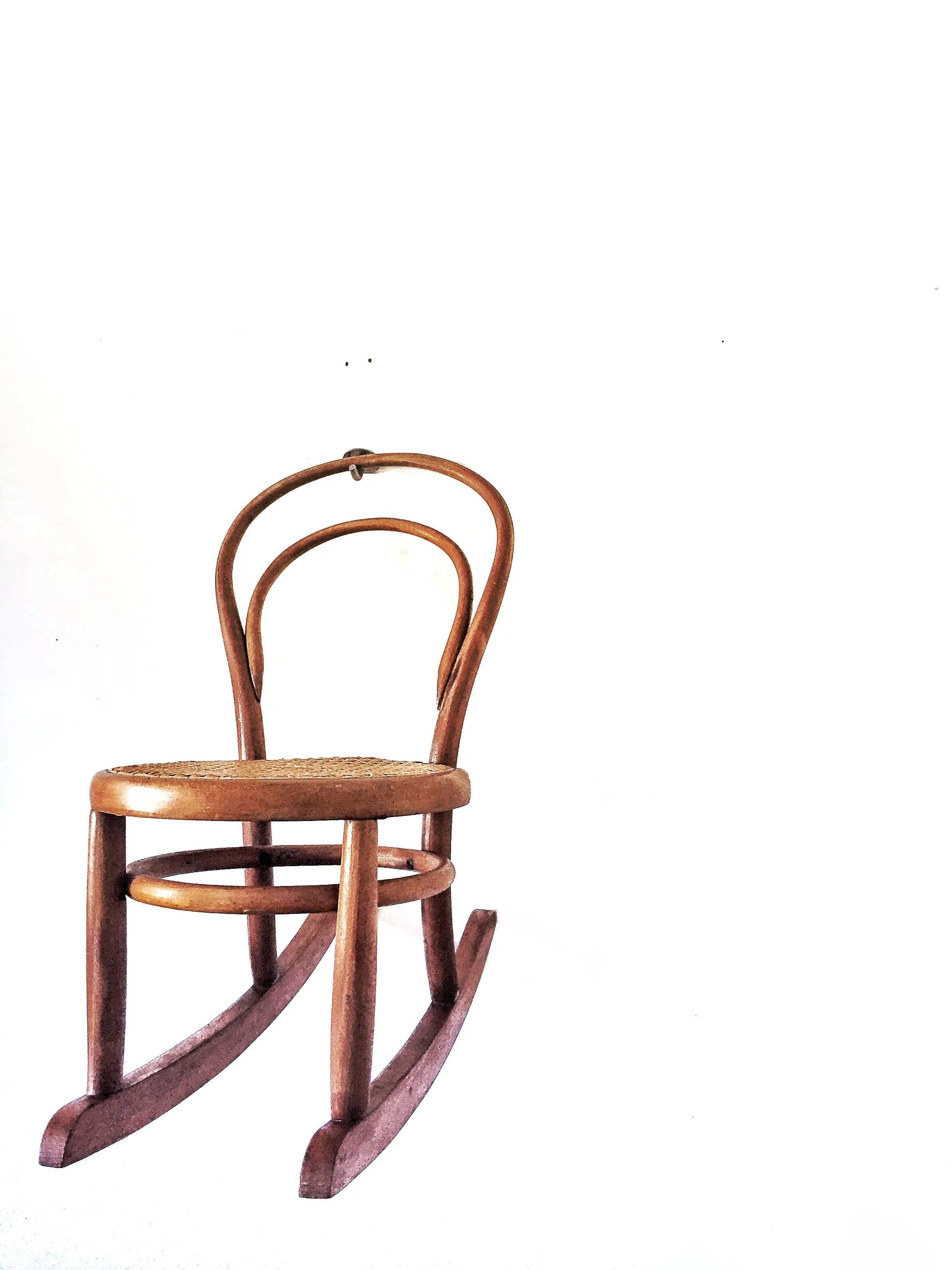 Vintage child’s bentwood rocker chair with woven wicker seat