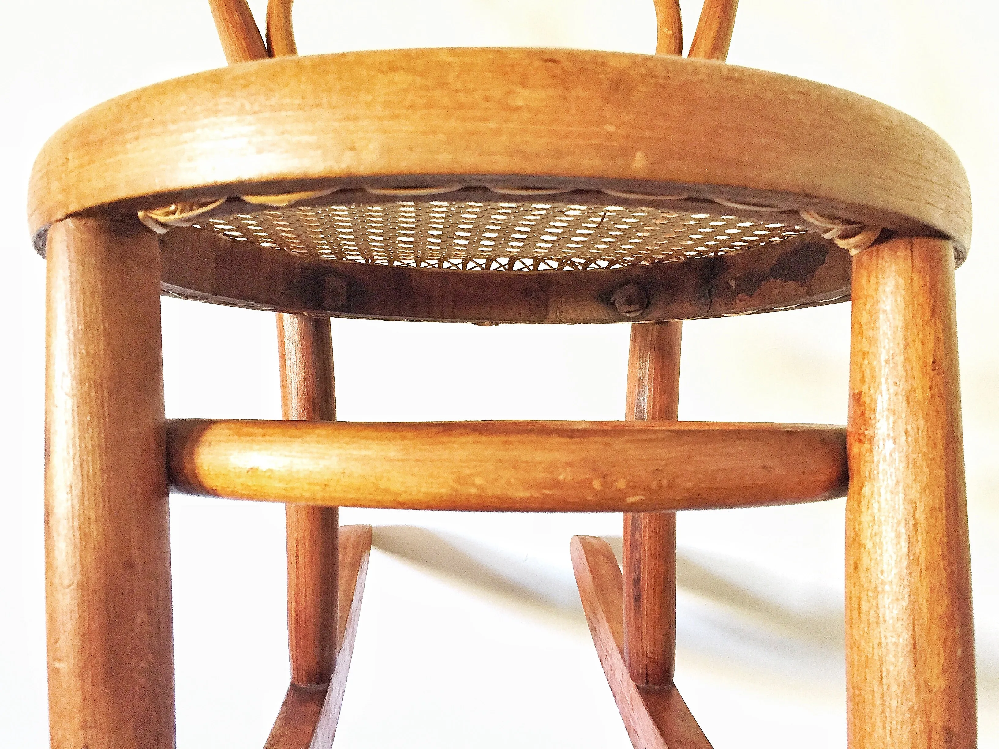 Vintage child’s bentwood rocker chair with woven wicker seat